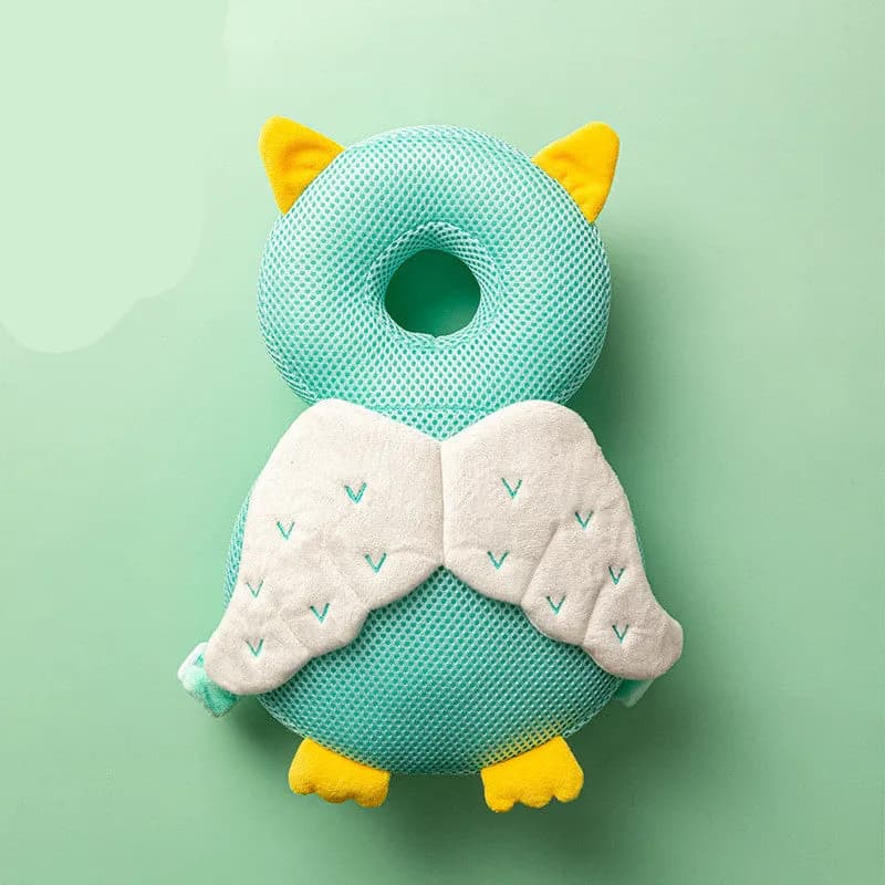Green Owl baby head protector backpack shown from the back with its adjustable shoulder harness